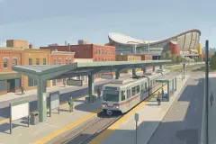 Light-rail station with an arena roof beyond